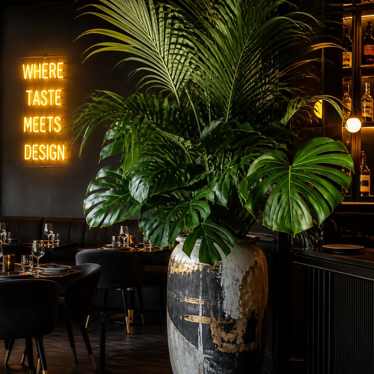 Monstera and palm fronds in a large artisan painted pot